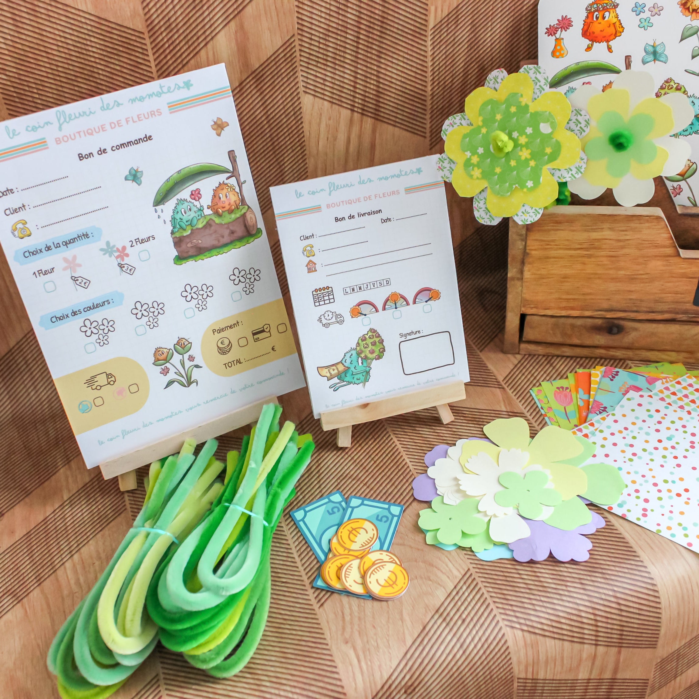 Photo des produits du kit de jeu d'imitation fleuriste avec les supports, la monnaie, les fleurs.